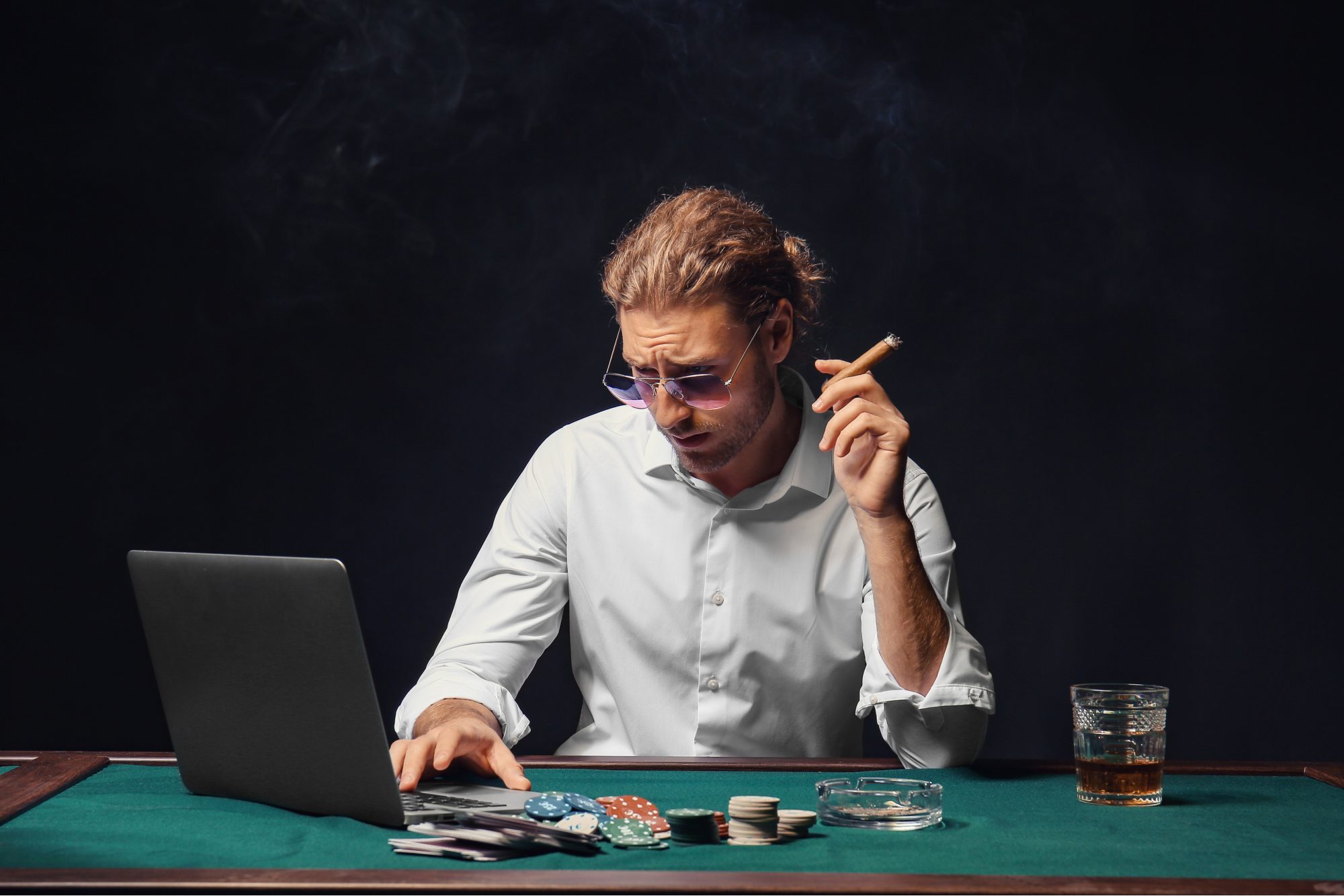 Picture of a guy focusing on online poker in front of his laptop