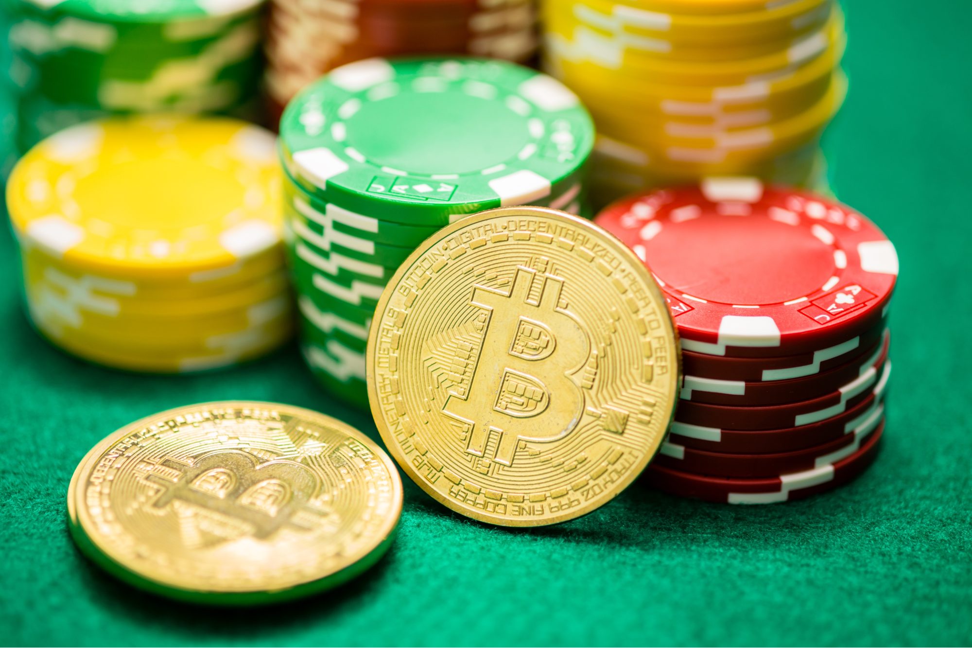 Picture of 2 bitcoins with the stack of casino chips in the background.